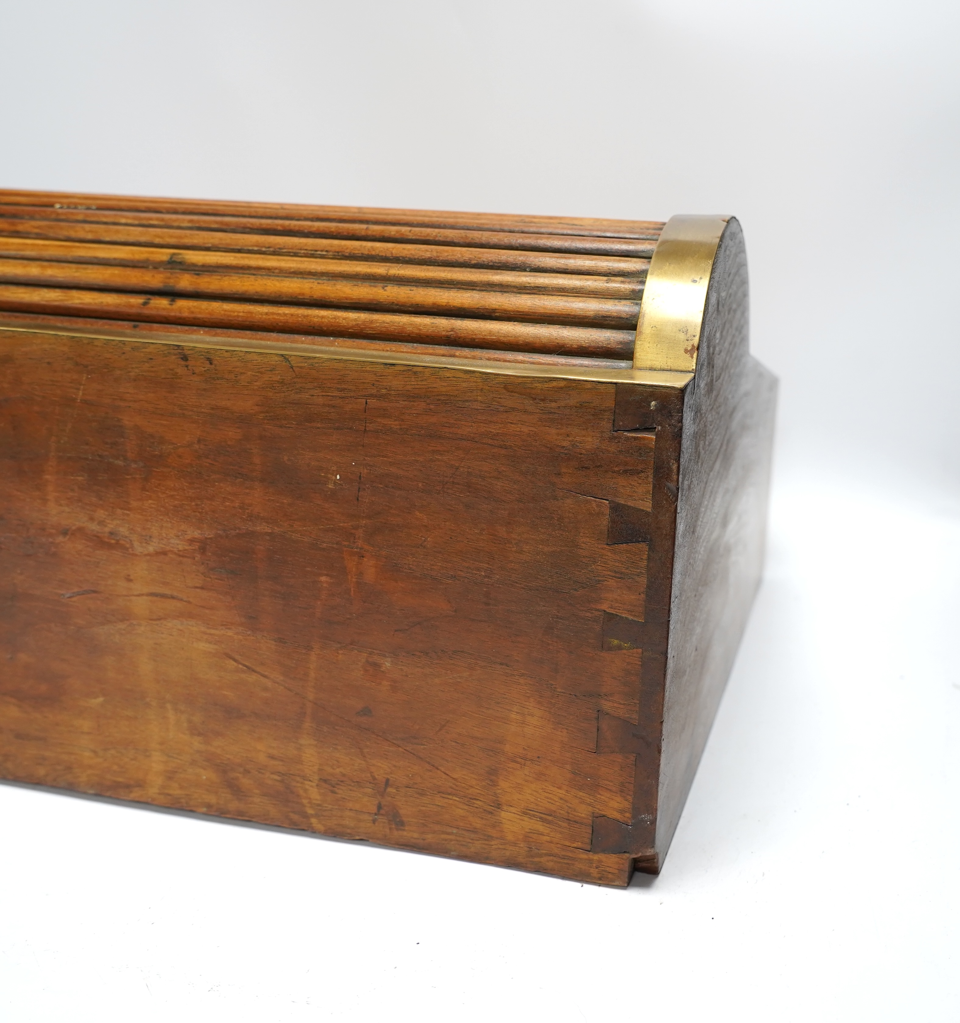 A 19th/20th century Anglo-Indian brass bound camphorwood roll top writing box, 47.5cm wide